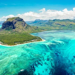 Aerial panoramic view of Mauritius island – Detail of Le Morne Brabant mountain with underwater waterfall perspective optic illusion – Wanderlust and travel concept with nature wonders on vivid filter